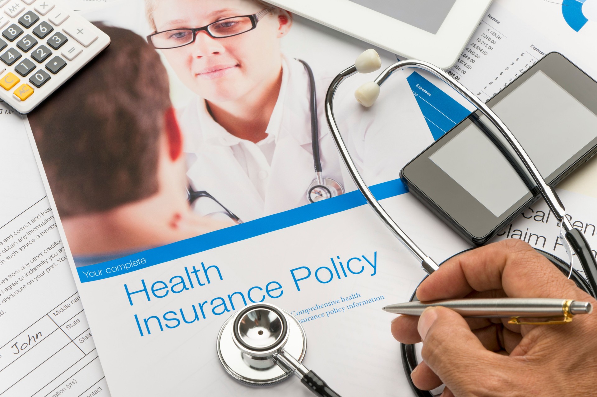 Health Insurance Policy brochure with paperwork.